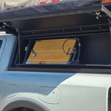 Alu-Cab fold-out table with integrated bamboo cutting board