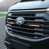 Close-up of a Ford vehicle's front grille with the logo.